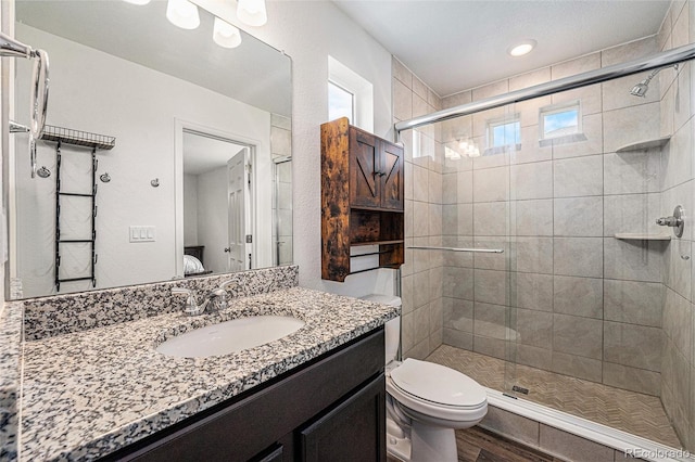 3934 N Quatar Ct, Aurora, CO 80019 - full bath with vanity, a stall shower, ensuite bath, and wood finished floors