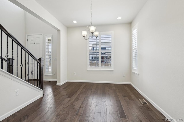 interior space featuring a chandelier and dark wood-type flooring