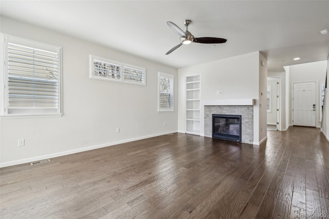 unfurnished living room featuring ceiling fan, built in features, and wood-type flooring