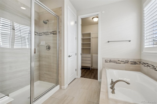 bathroom with independent shower and bath and tile patterned floors