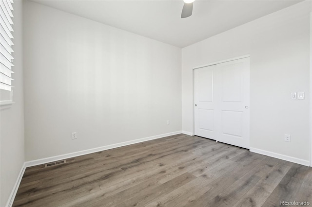 unfurnished bedroom featuring a closet, ceiling fan, and hardwood / wood-style flooring