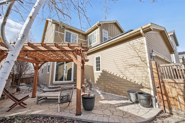 rear view of property featuring a patio and a pergola