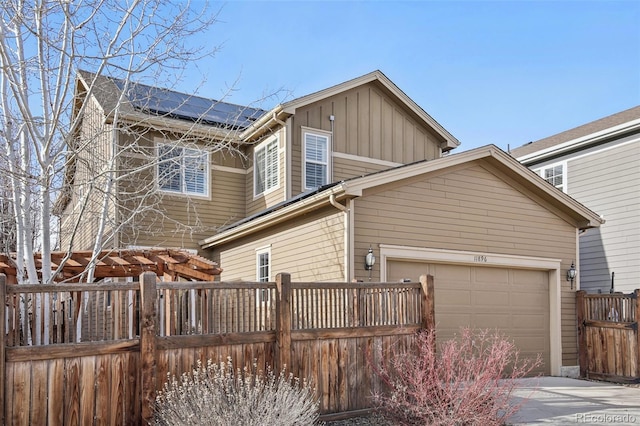 exterior space featuring solar panels and a garage