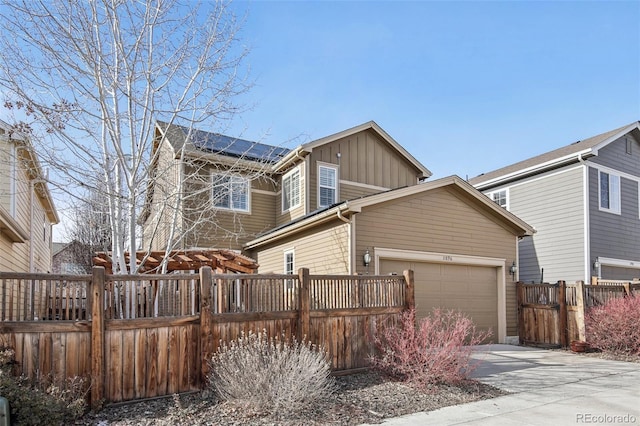 view of front of home featuring a garage and solar panels