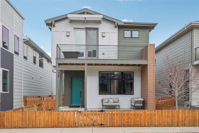 modern home with a balcony and a porch