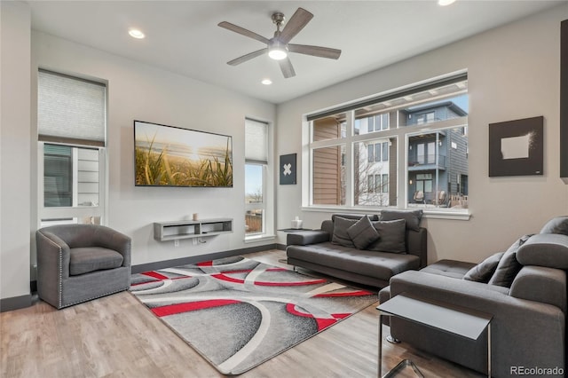 living room featuring ceiling fan and hardwood / wood-style floors