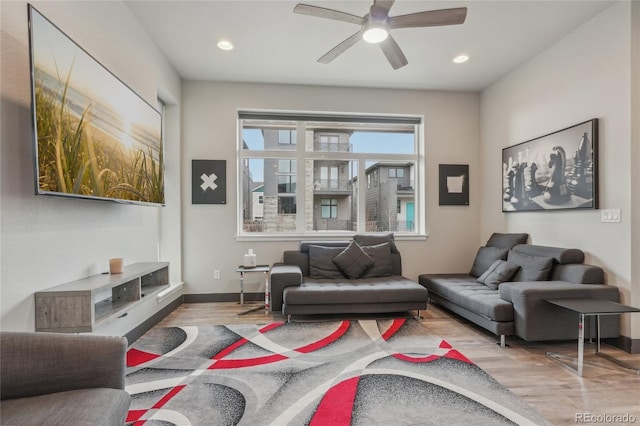 living room featuring ceiling fan and light wood-type flooring