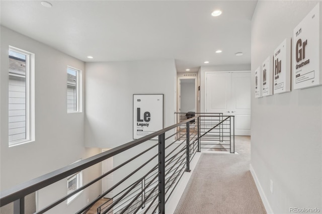 corridor with light colored carpet