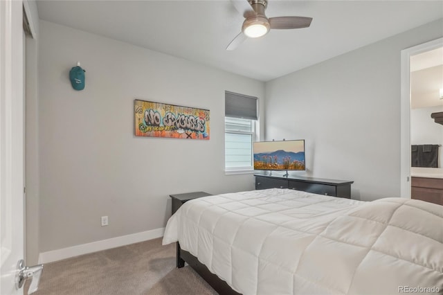 bedroom with light carpet, connected bathroom, and ceiling fan