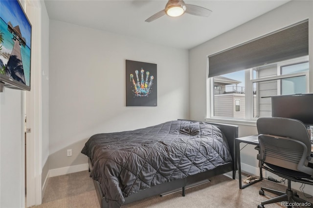 bedroom with ceiling fan and light colored carpet