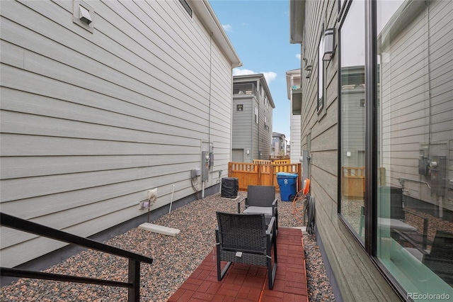 view of side of home with an outdoor hangout area, a patio, and central air condition unit