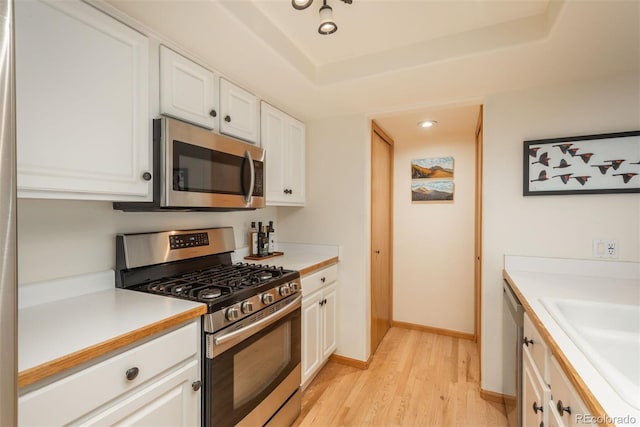 23624 Pondview Pl Unit G, Golden, CO 80401 - kitchen with stainless steel appliances, light wood finished floors, white cabinetry, and light countertops