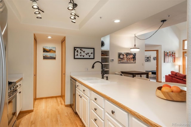 23624 Pondview Pl Unit G, Golden, CO 80401 - kitchen with stainless steel appliances, light wood-style floors, a raised ceiling, and white cabinets