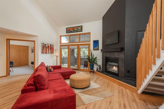 23624 Pondview Pl Unit G, Golden, CO 80401 - living area featuring wood finished floors, a fireplace, high vaulted ceiling, and stairway