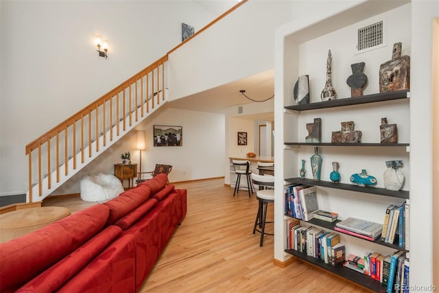 23624 Pondview Pl Unit G, Golden, CO 80401 - living room featuring stairway, wood finished floors, and a high ceiling