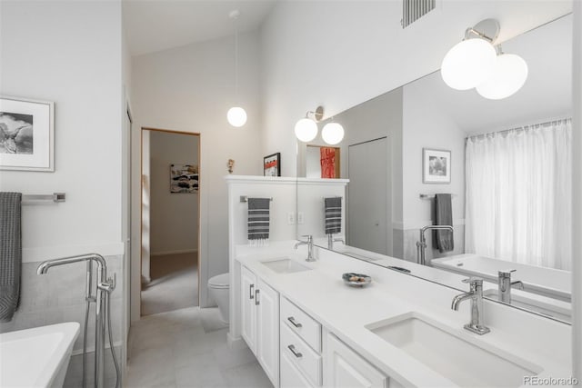 23624 Pondview Pl Unit G, Golden, CO 80401 - full bathroom with a bath, double vanity, and high vaulted ceiling