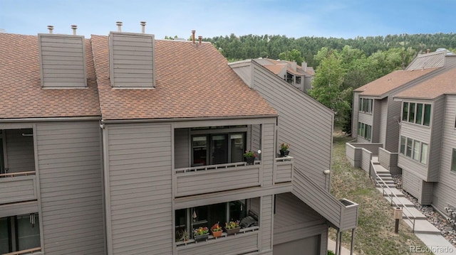 23624 Pondview Pl Unit G, Golden, CO 80401 - rear view of property with a shingled roof and a chimney