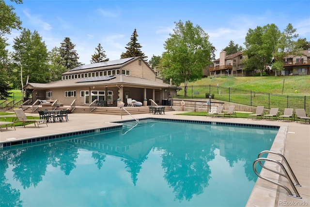 23624 Pondview Pl Unit G, Golden, CO 80401 - community pool featuring a patio, a fenced backyard, a sunroom, and outdoor dining area