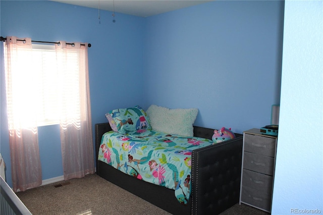 bedroom with carpet floors and baseboards