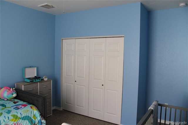 bedroom featuring dark colored carpet and a closet