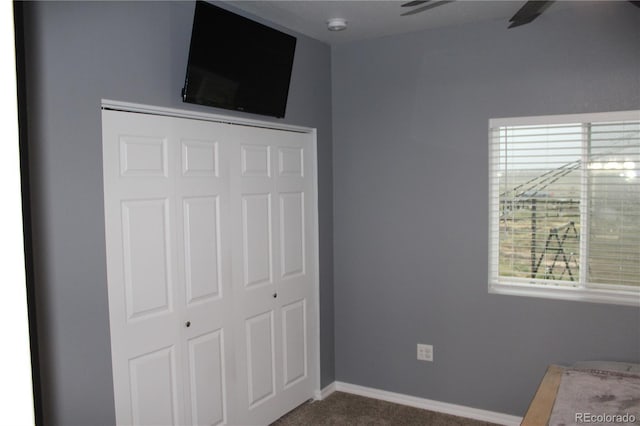 unfurnished bedroom with a closet, baseboards, and carpet flooring