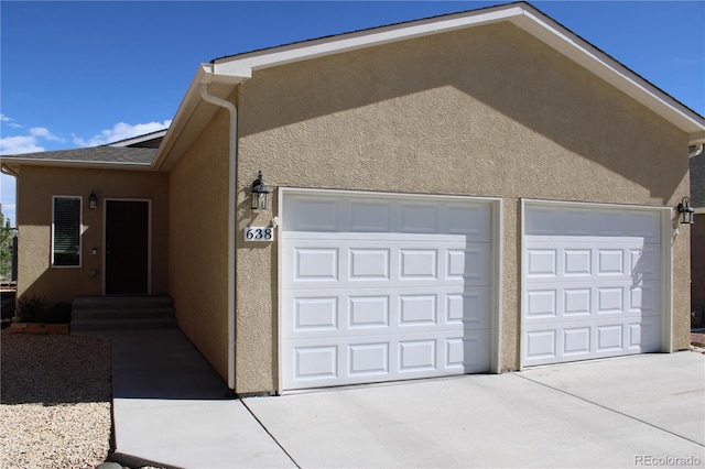 view of property exterior featuring stucco siding and driveway
