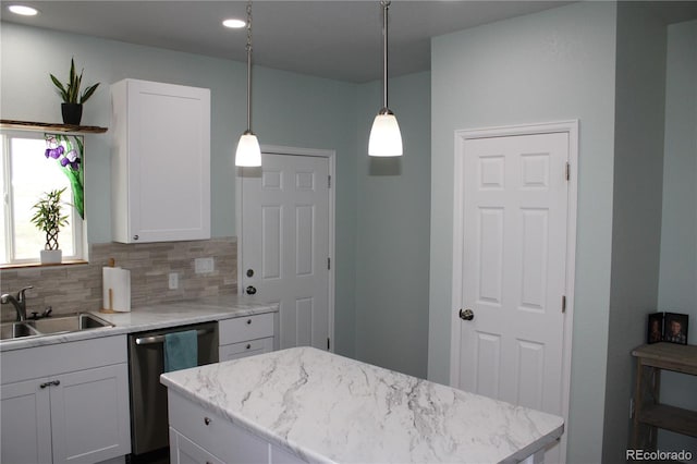 kitchen featuring stainless steel dishwasher, a sink, white cabinets, tasteful backsplash, and recessed lighting