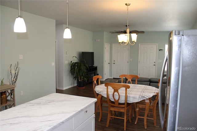dining room featuring dark wood-style flooring and a ceiling fan