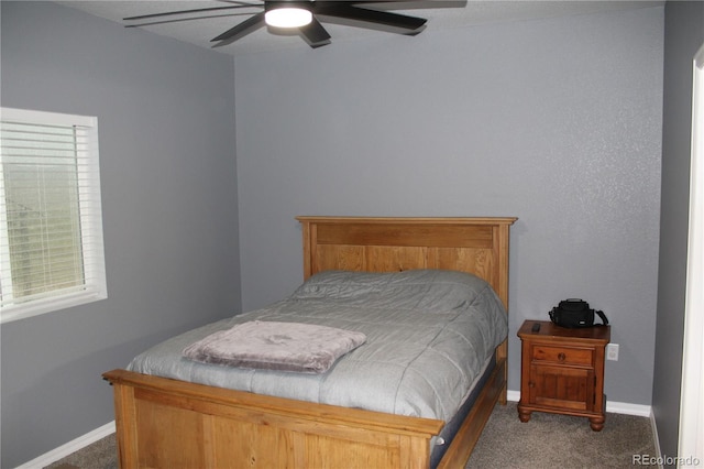 carpeted bedroom featuring baseboards and ceiling fan