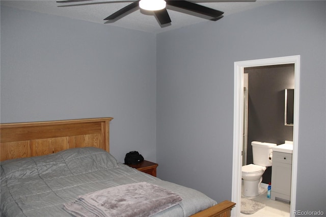 bedroom with a ceiling fan and ensuite bath