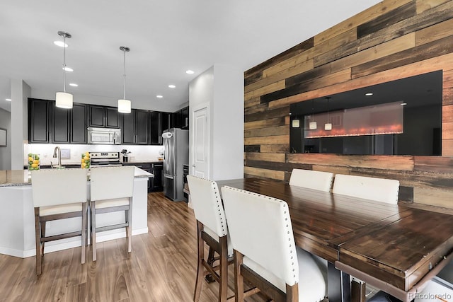 19210 E Pacific Pl, Aurora, CO 80013 - dining space with wood walls, wood finished floors, and recessed lighting
