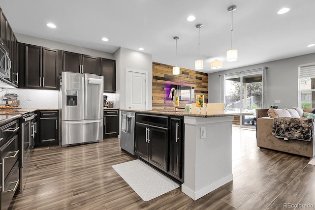 19210 E Pacific Pl, Aurora, CO 80013 - kitchen with stainless steel appliances, backsplash, recessed lighting, light stone counters, and dark wood-style floors