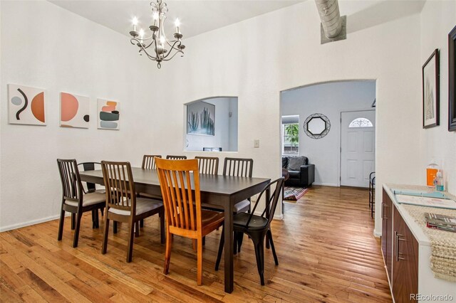 915 26th St, Denver, CO 80205 - dining room with a chandelier, light wood-style floors, and a high ceiling