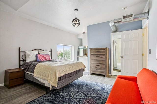 915 26th St, Denver, CO 80205 - bedroom with wood finished floors and ensuite bath