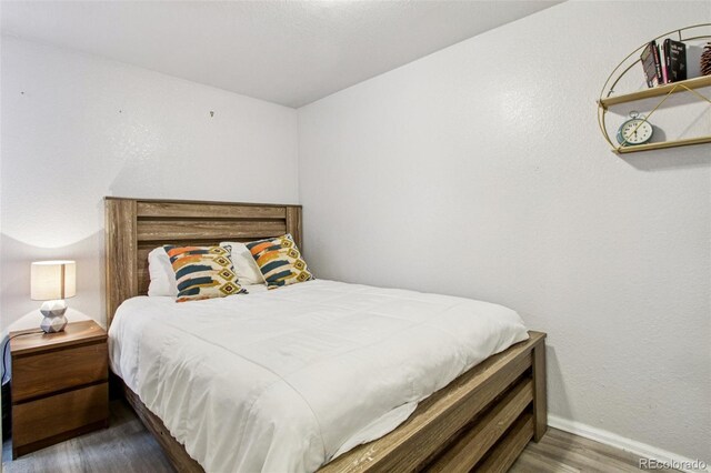 915 26th St, Denver, CO 80205 - bedroom with wood finished floors and baseboards