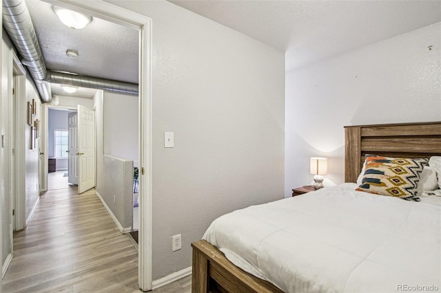 915 26th St, Denver, CO 80205 - bedroom with wood finished floors and baseboards