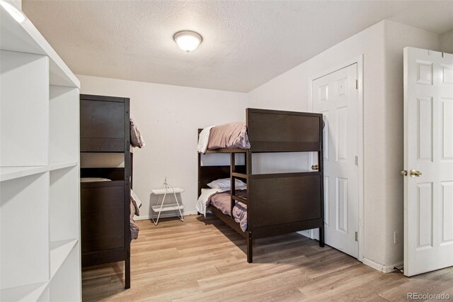 915 26th St, Denver, CO 80205 - bedroom featuring light wood-style flooring and a textured ceiling