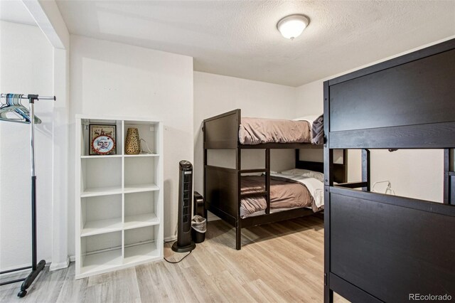 915 26th St, Denver, CO 80205 - bedroom with wood finished floors and a textured ceiling