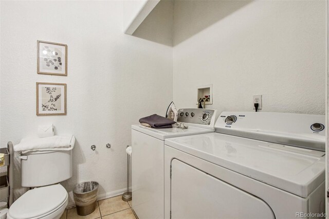 915 26th St, Denver, CO 80205 - laundry area with washer and clothes dryer and light tile patterned floors
