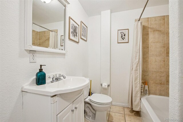 915 26th St, Denver, CO 80205 - bathroom featuring vanity, tile patterned floors, shower / tub combo with curtain, and a textured wall