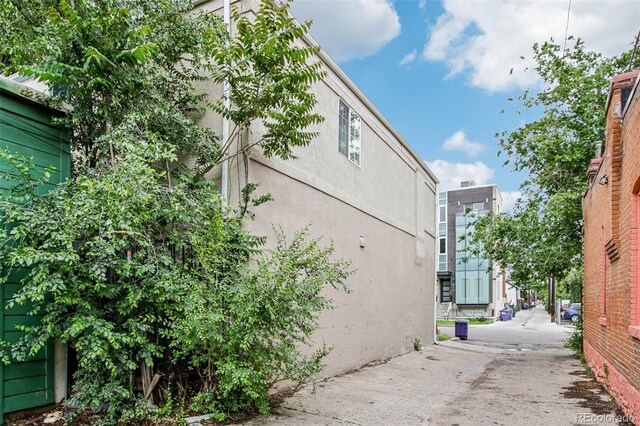 915 26th St, Denver, CO 80205 - view of home's exterior featuring stucco siding and a patio area