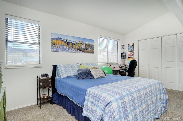 bedroom featuring baseboards, vaulted ceiling, carpet, and a closet