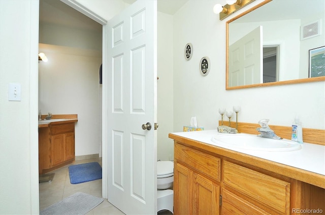 bathroom with toilet, tile patterned floors, visible vents, and vanity