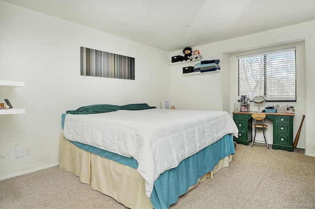 bedroom with carpet floors and baseboards