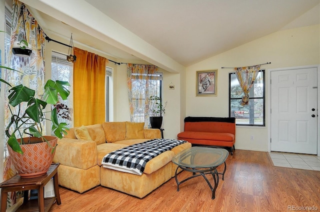 living area with vaulted ceiling and wood finished floors