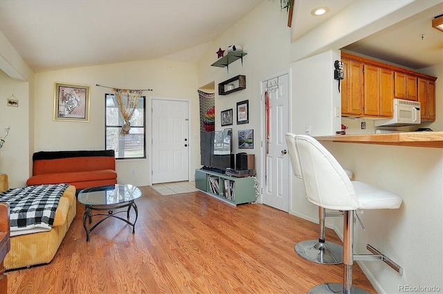 living room featuring light wood-style flooring and lofted ceiling
