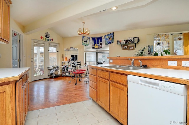 kitchen with a sink, dishwasher, a notable chandelier, and light countertops