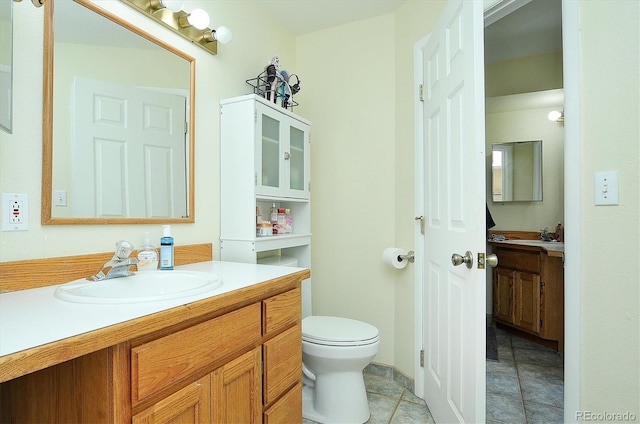 bathroom with vanity, tile patterned floors, and toilet