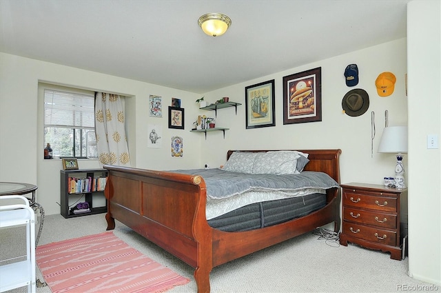 bedroom featuring light carpet
