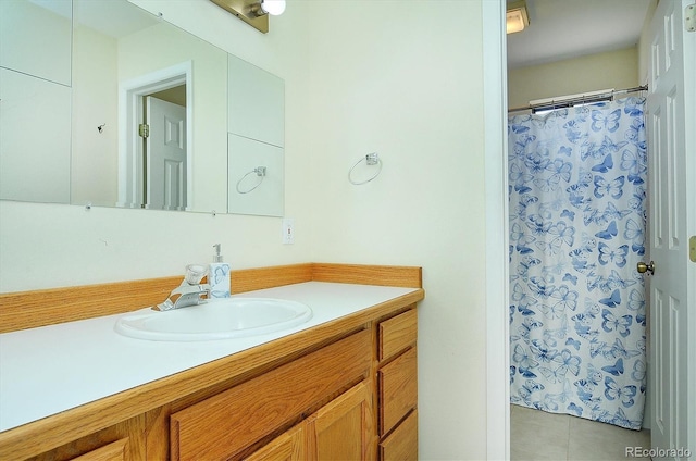 bathroom featuring a shower with shower curtain, tile patterned flooring, and vanity